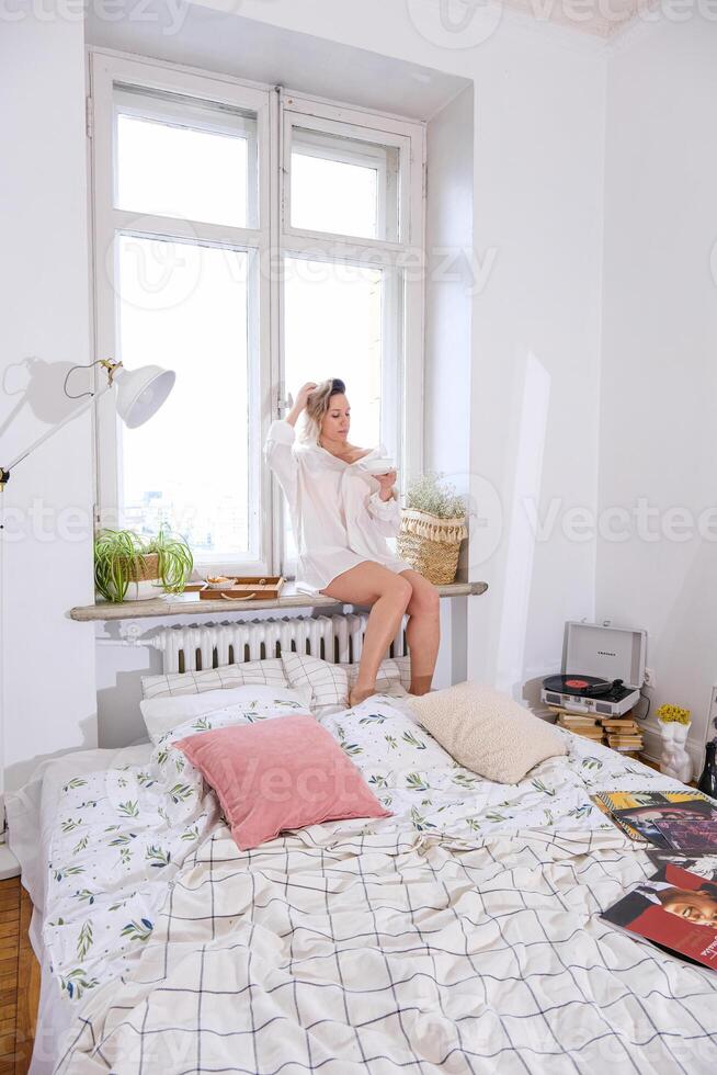 A woman sitting on a bed photo