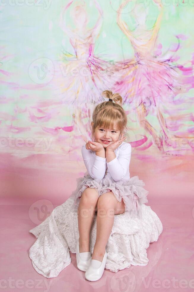 Cute Ballerina Doing Exercises Set in the studio photo