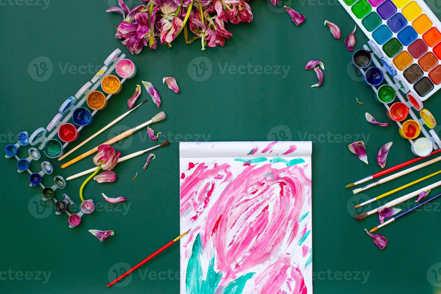 A painting of flowers on a green table photo