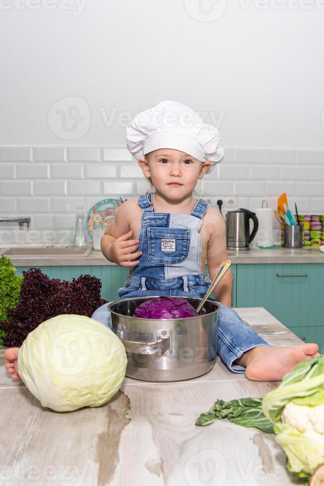 A little boy in a chef hat photo