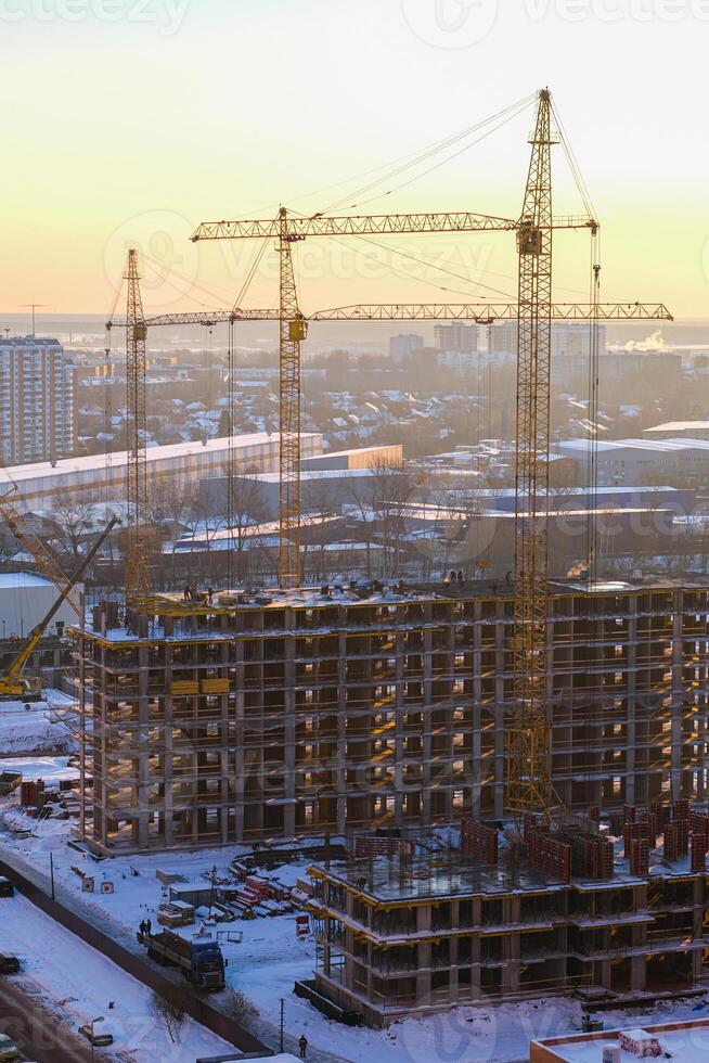 Construction site with cranes and buildings in the background photo