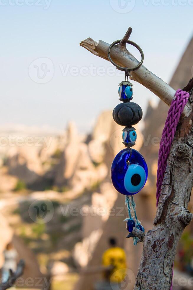 A blue evil eye on a tree branch photo