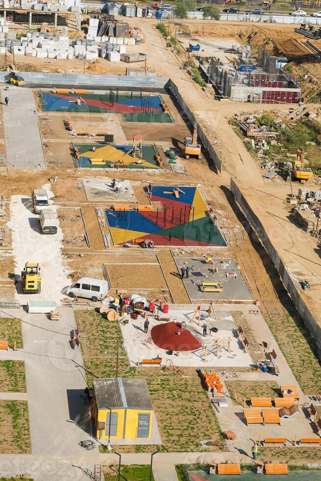 A construction site with a playground and a building photo