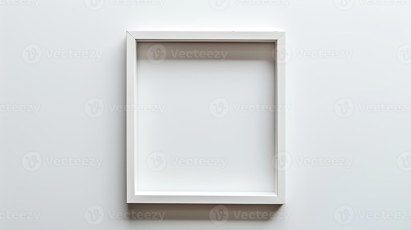 White picture frame on white wall. Empty space for your design. photo