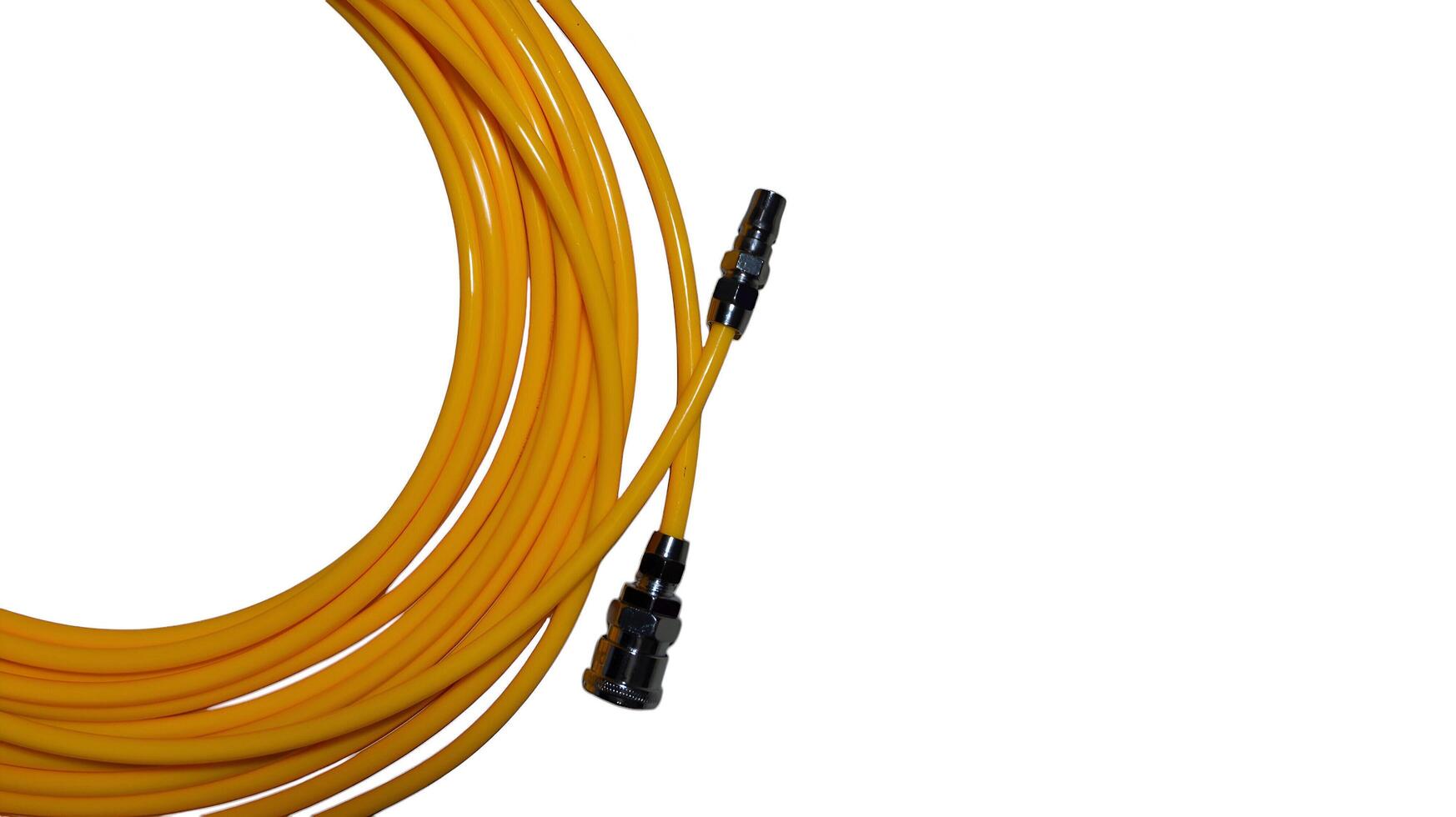 Bright yellow air compressor hose with quick connect fittings on white photo