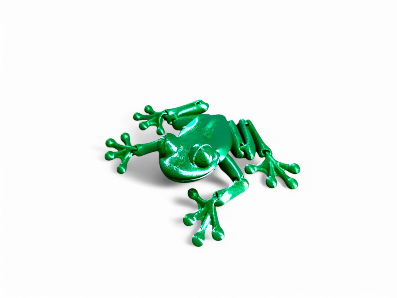 A green plastic frog on a white background photo