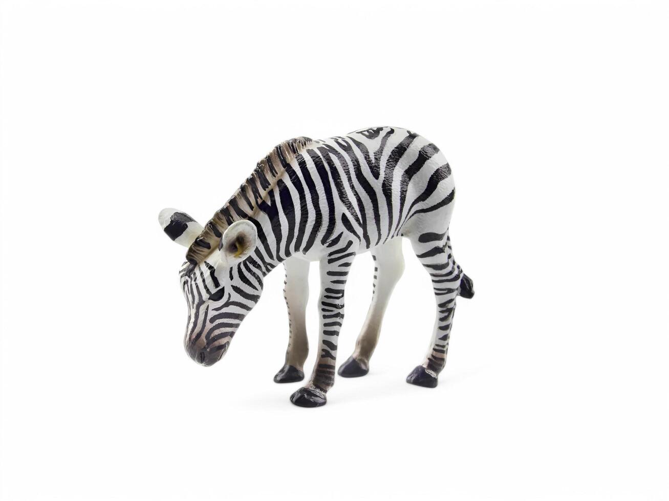 A toy zebra standing on a white background photo
