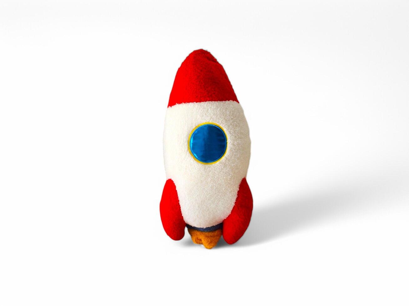 A red and white stuffed toy rocket photo