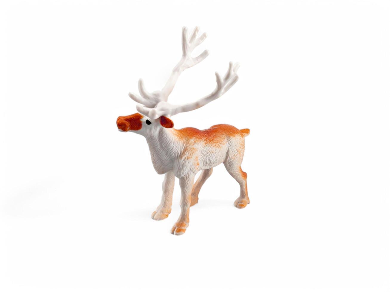 A toy reindeer with a white and orange nose photo