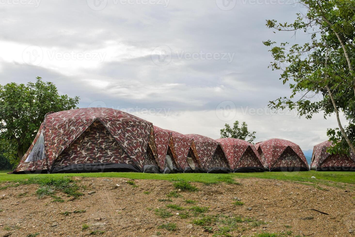 Row of camping tents on hill photo