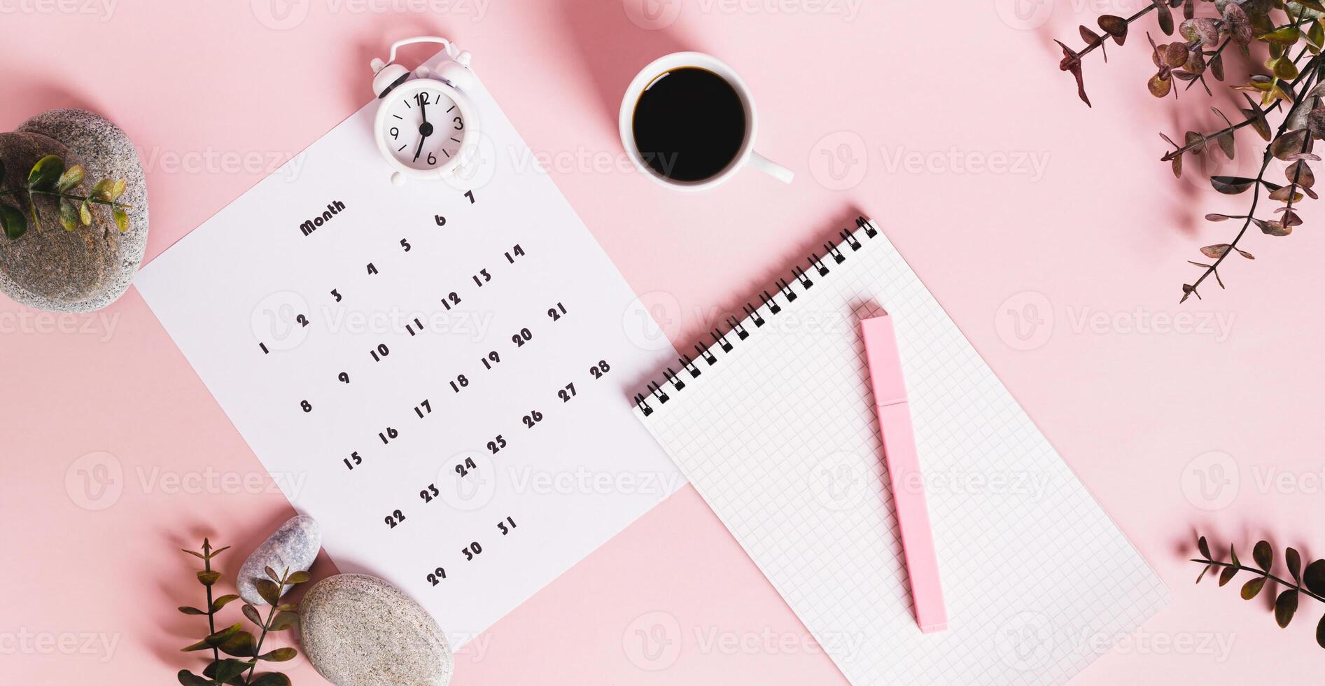 Monthly calendar and blank planning notebook on the desktop top view web banner photo