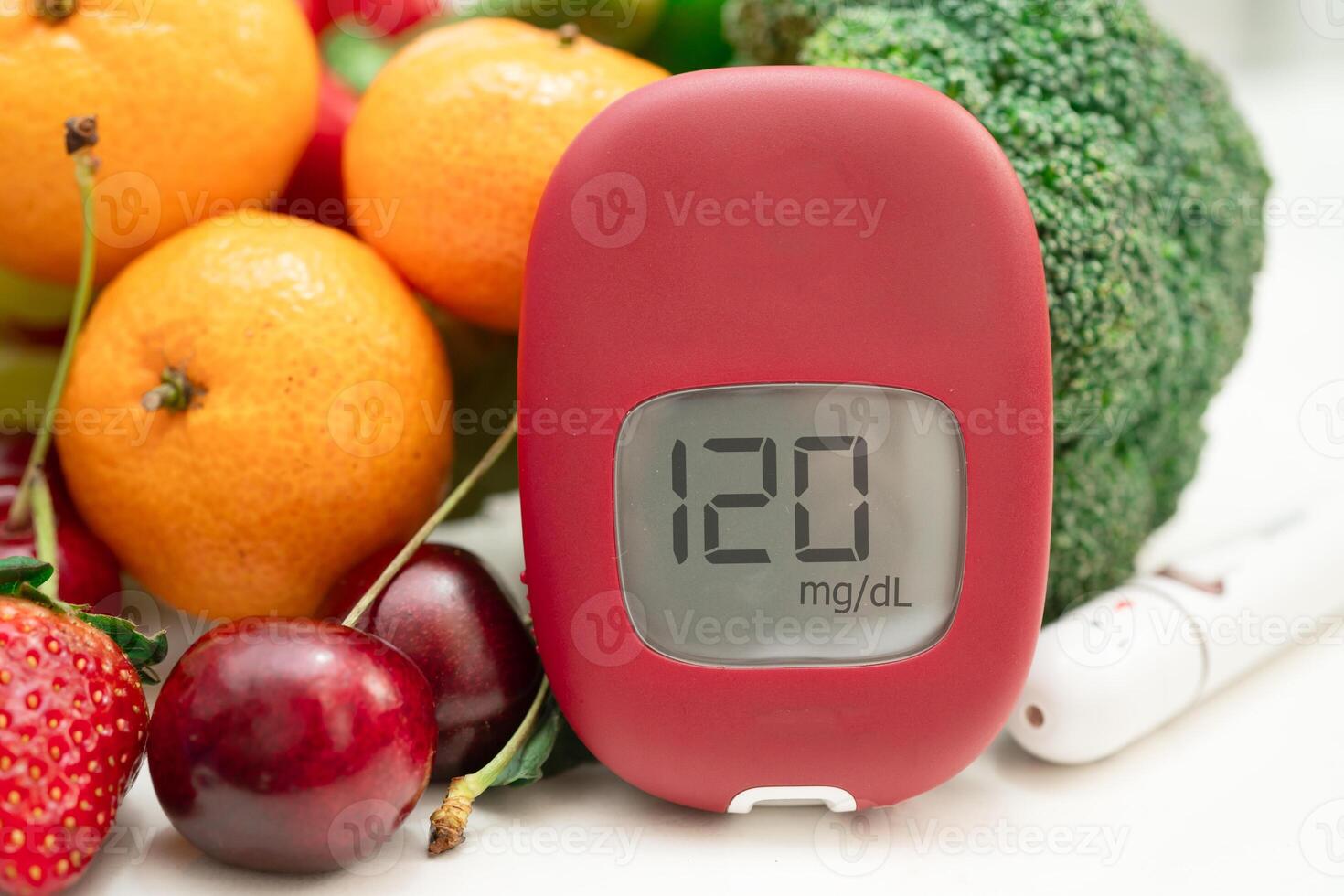 Glucose meter with vegetable and fruit for check sample blood sugar level to treatment photo