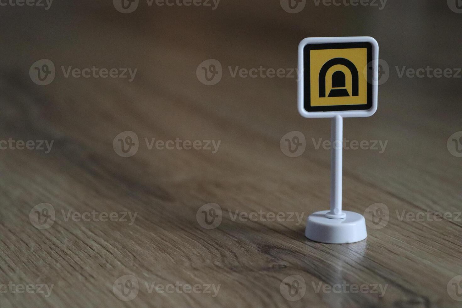 A small, stylish sign placed on a wooden floor adds a unique and chic decor element photo