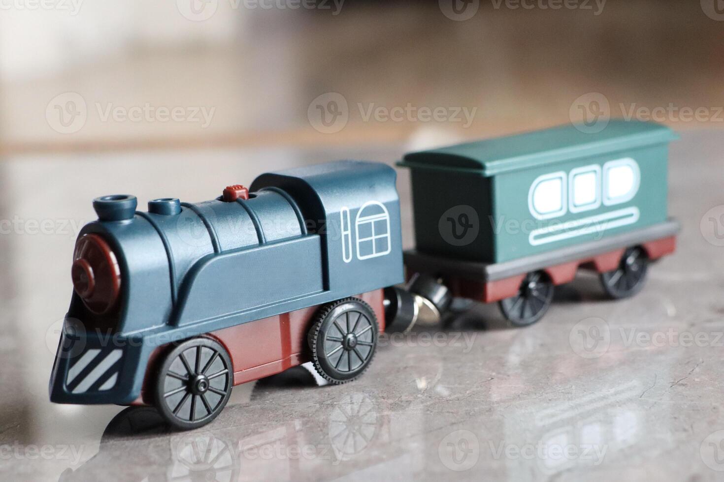 A Colorful and Charming Wooden Toy Train Featuring a Bright Green Freight Car for Kids photo