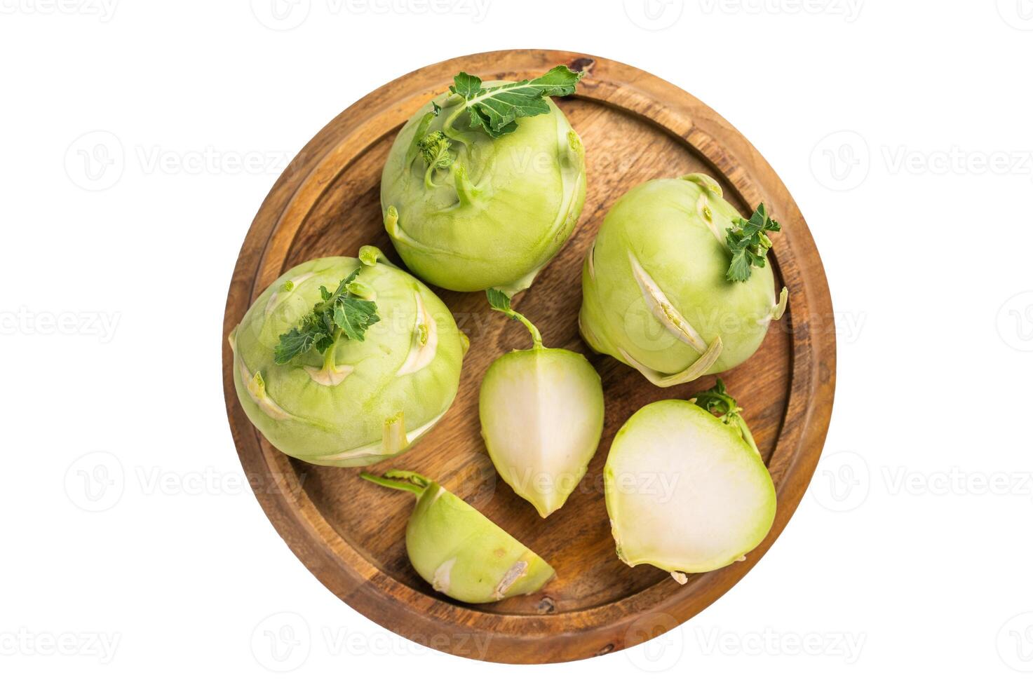 Raw kohlrabi sliced on pieces on wooden tray isolated on white backround. top view photo