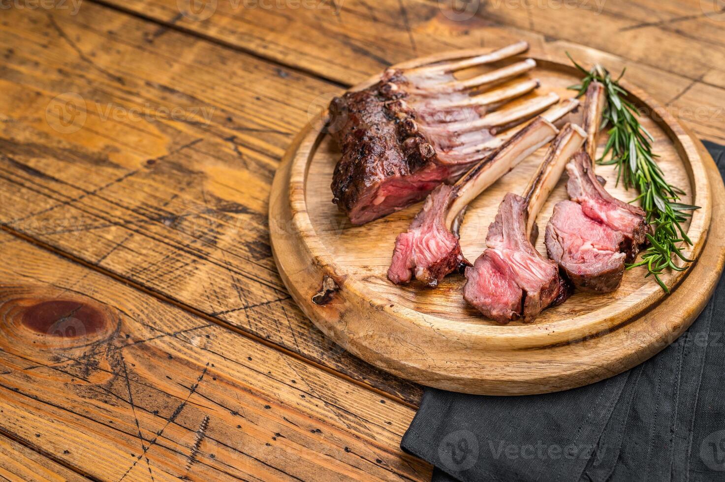 Grilled lamb chops, mutton meat cutlets steaks on wooden board. wooden background. top view photo