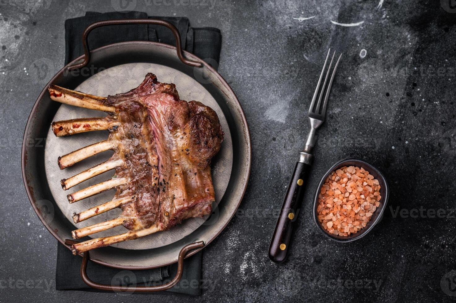 Roast Rack of lamb chops mutton organic meat. black background. top view photo