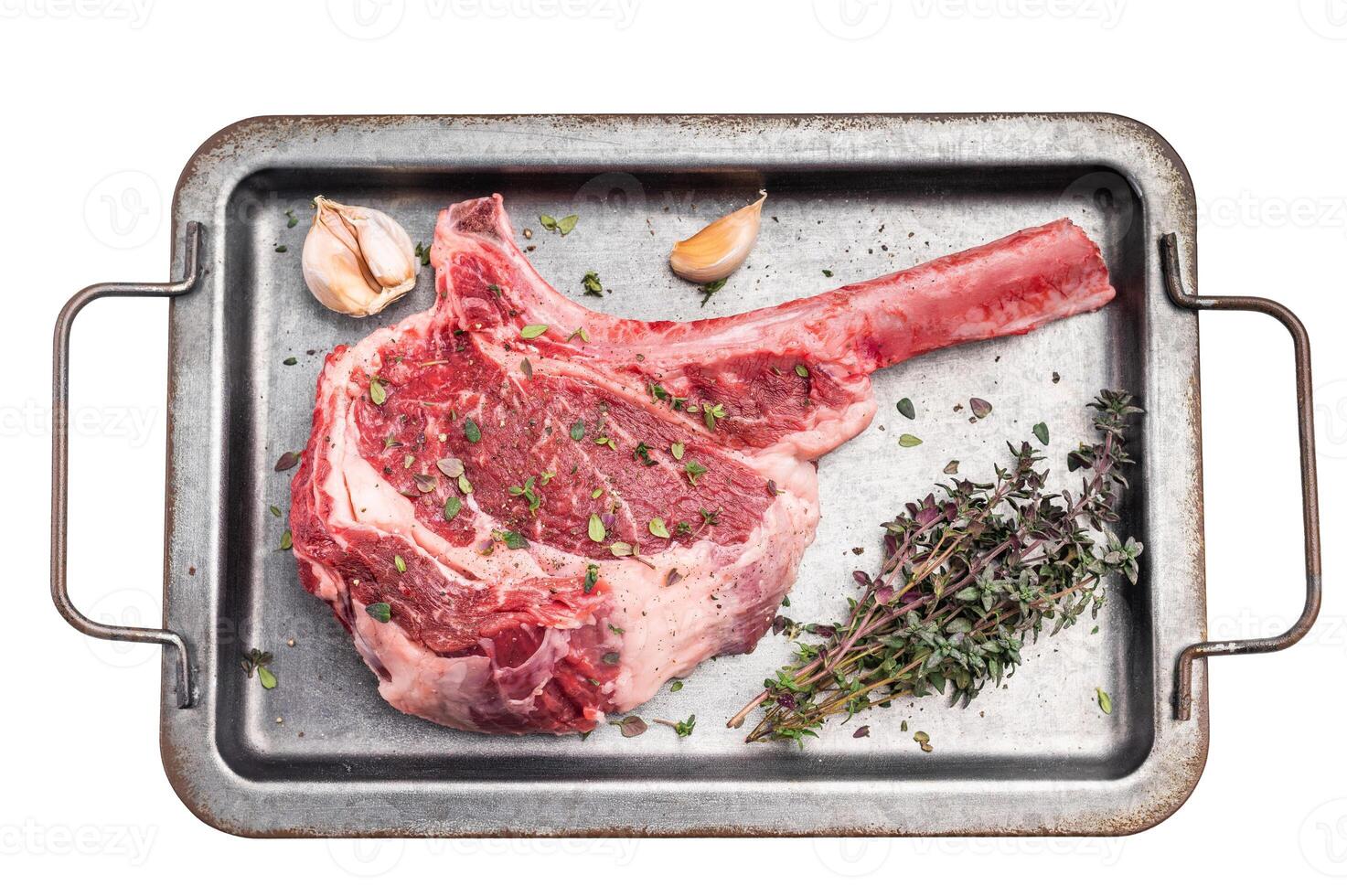Ready for cooking Tomahawk beef steak with seasonings, raw marbled rib eye with bone on steel tray Isolated on a white background. top view photo
