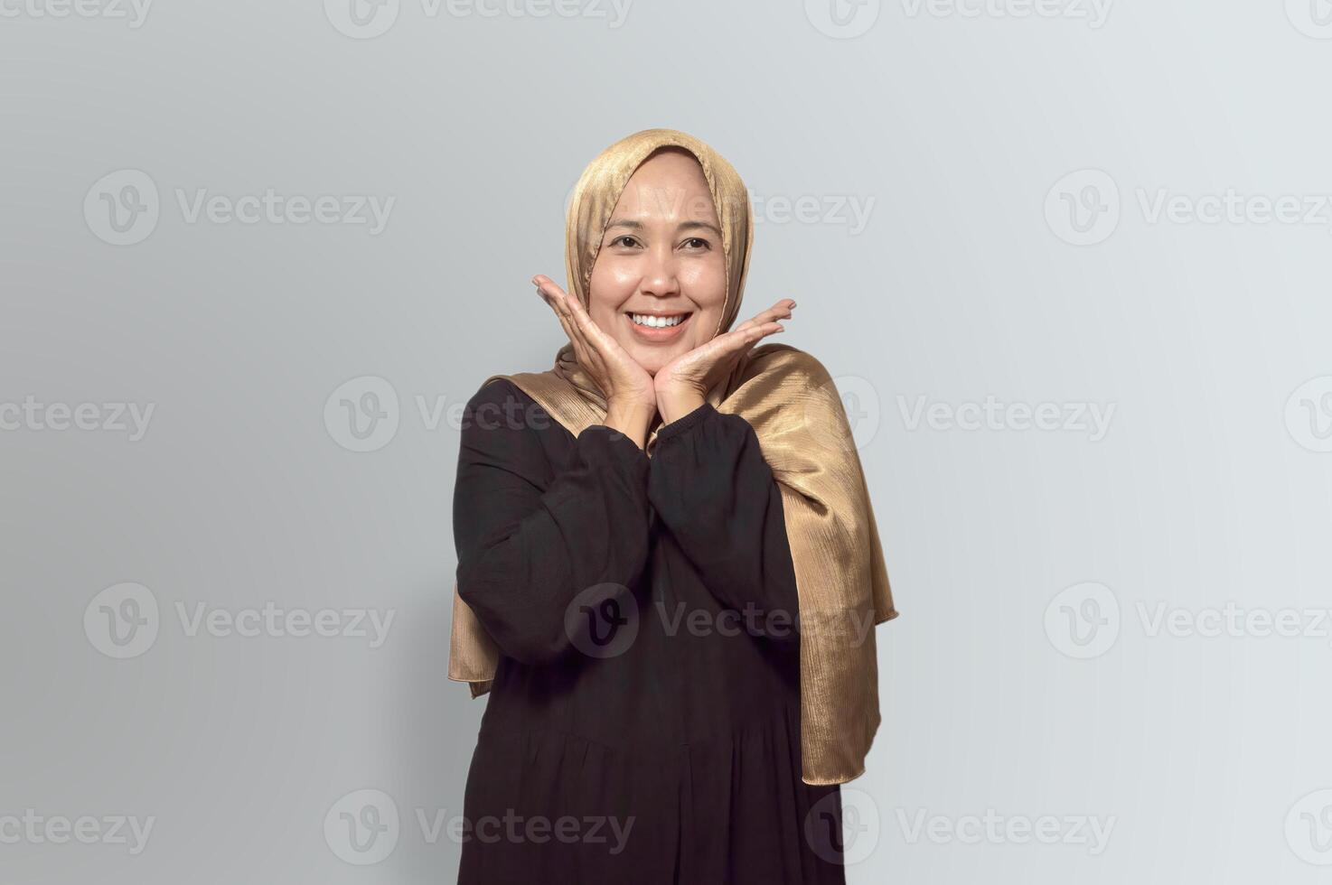 Cheerful Woman in Golden Hijab Making a Cute Pose photo
