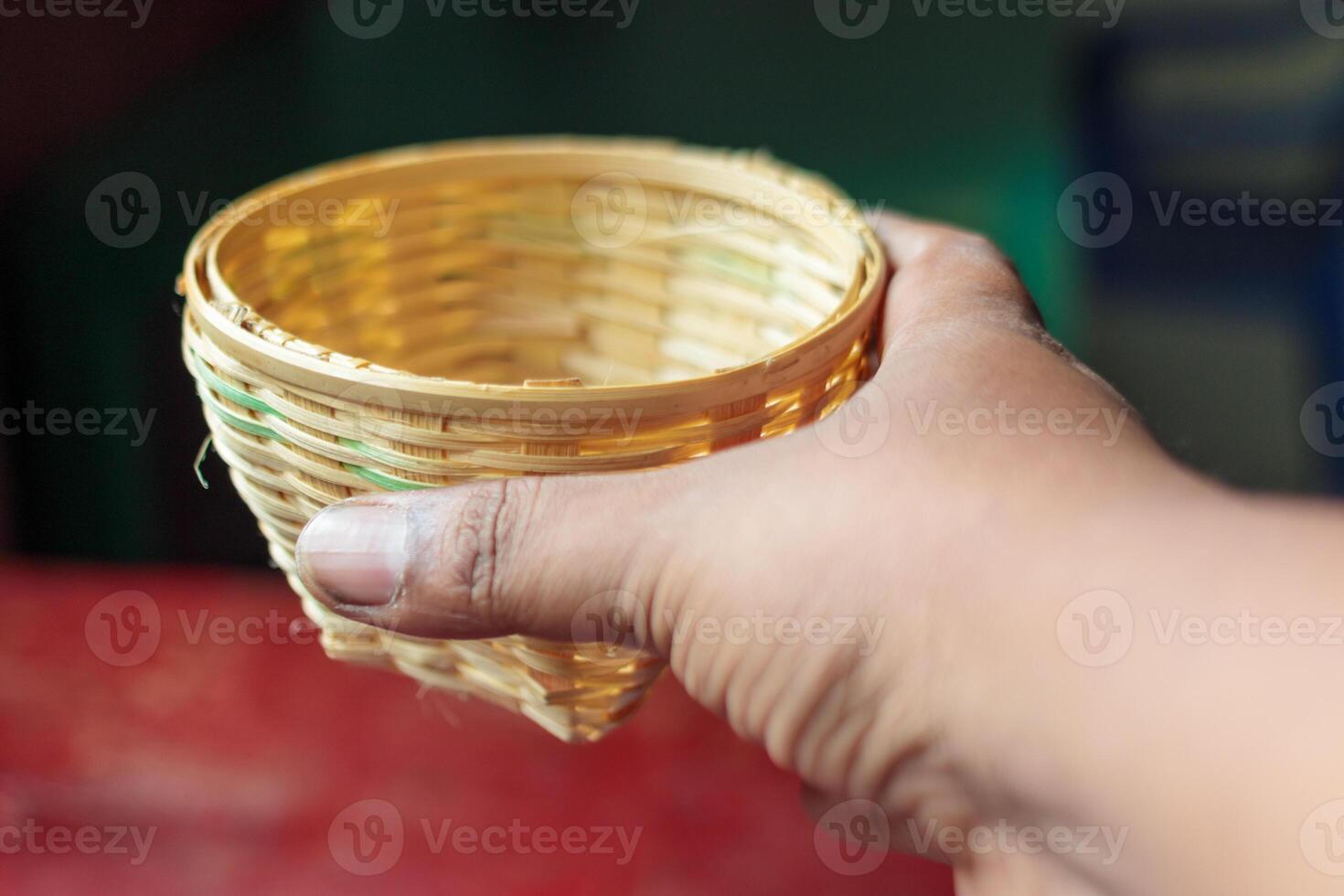 Hand Holding a Small Woven Bamboo Basket , Eco Friendly Craft photo