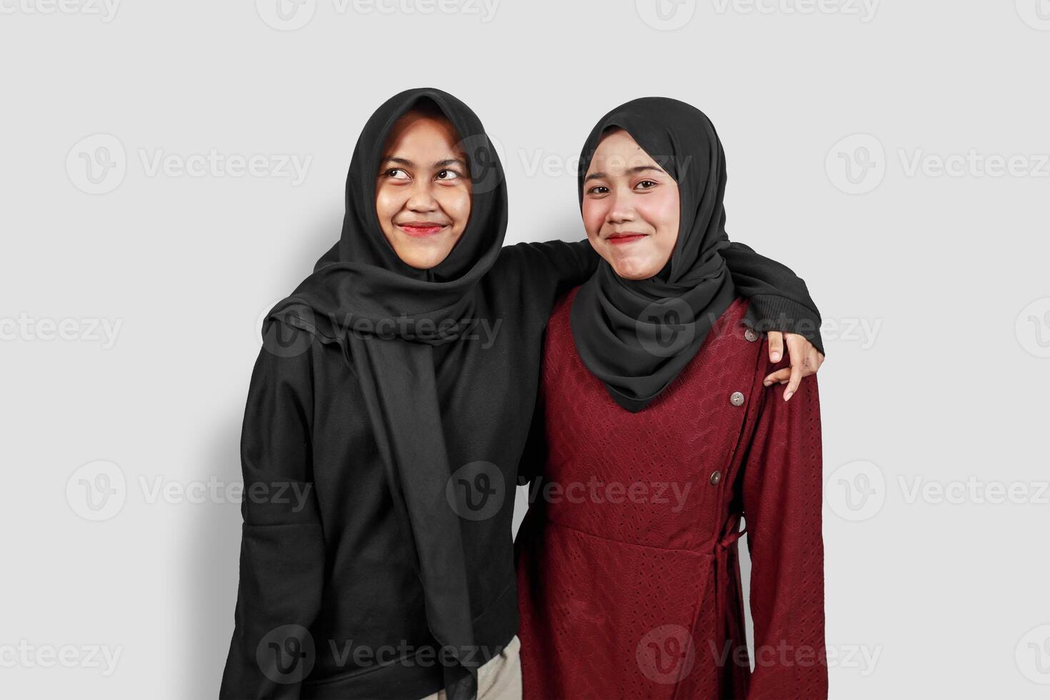 Two Muslim Women Smiling and Hugging in Hijabs photo