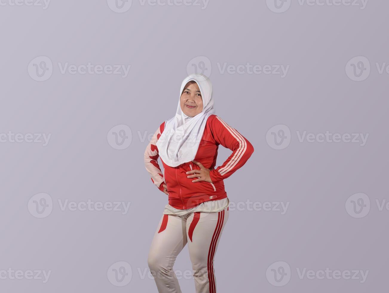 Confident Muslim Woman in Sportswear Posing with Hands on Waist photo