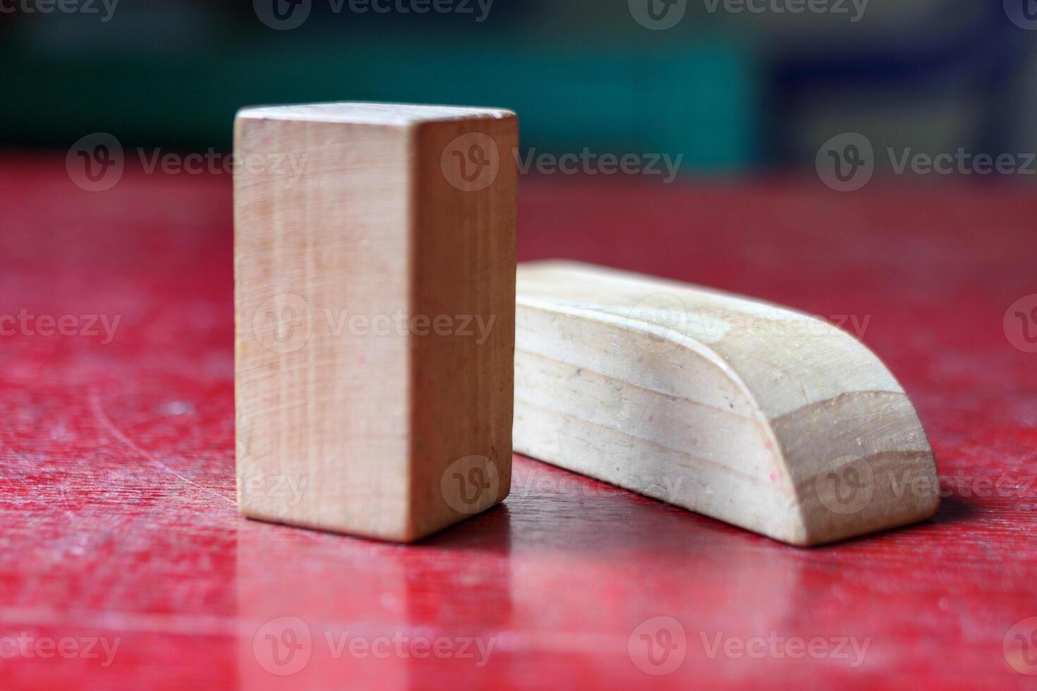 Minimalist Wooden Blocks on a Rustic Red Surface photo