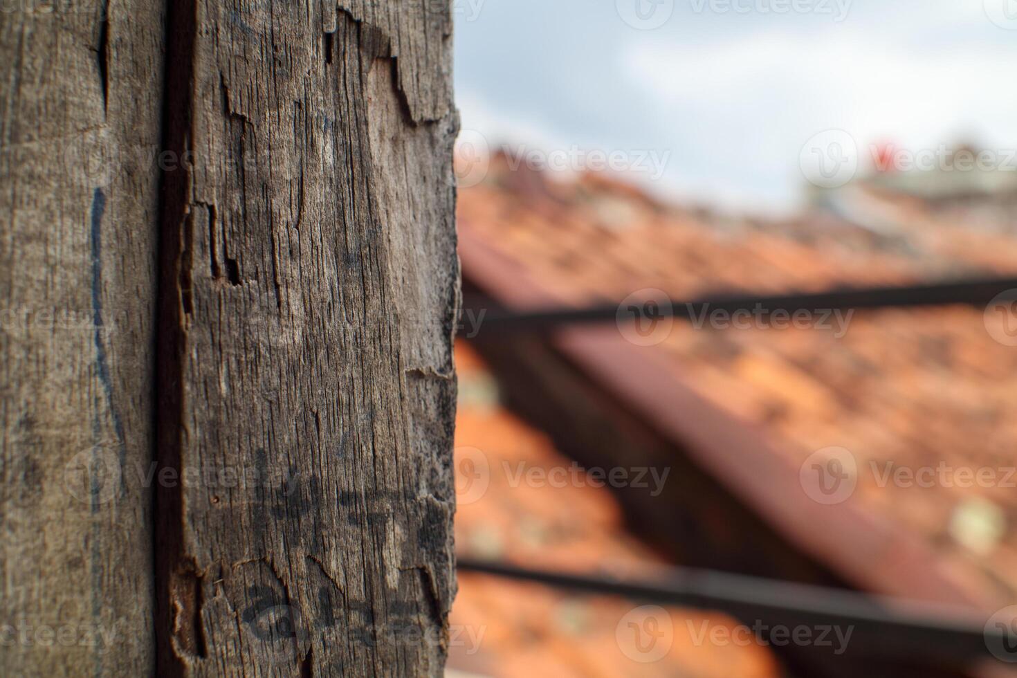 Close-Up of Weathered Wooden Post with Soft Urban Background photo