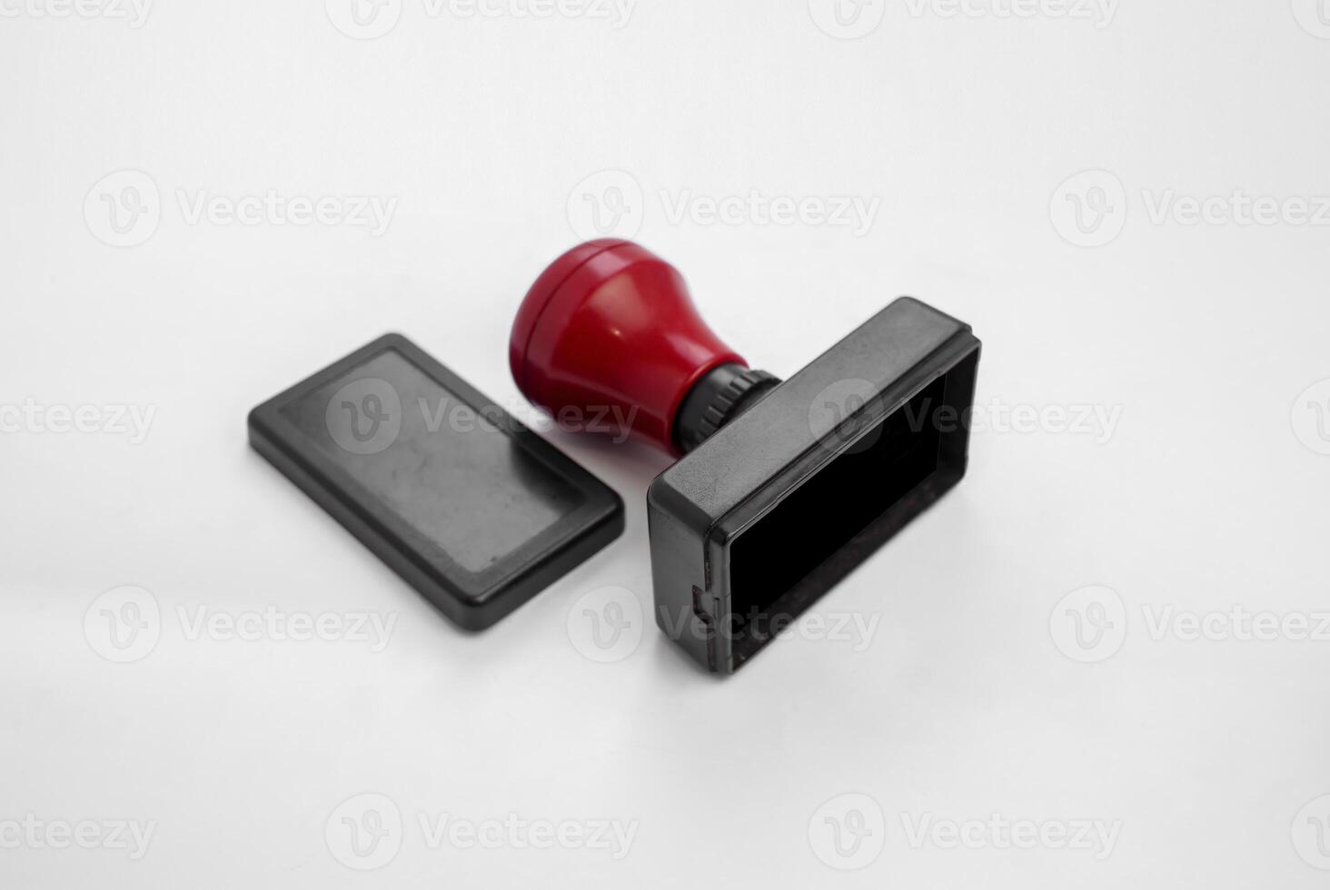 Red Rubber Stamp with Lid on White Background photo