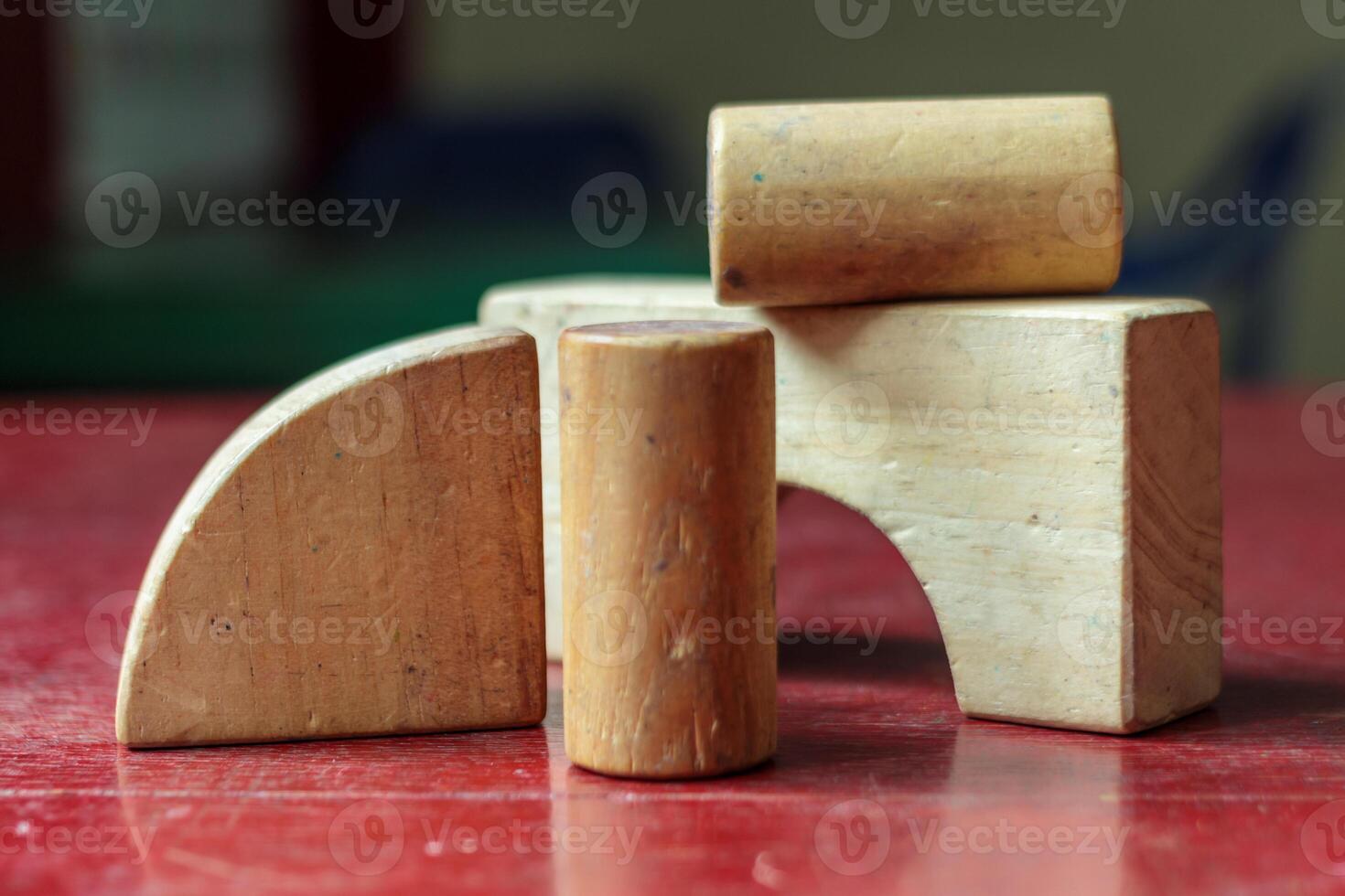 Wooden Geometric Blocks on Red Table, Educational and Minimalist Composition photo