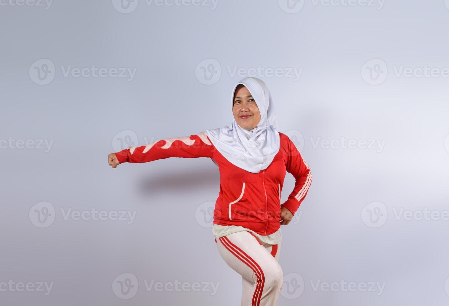 Sporty Muslim Woman Posing in Red Activewear and Hijab photo