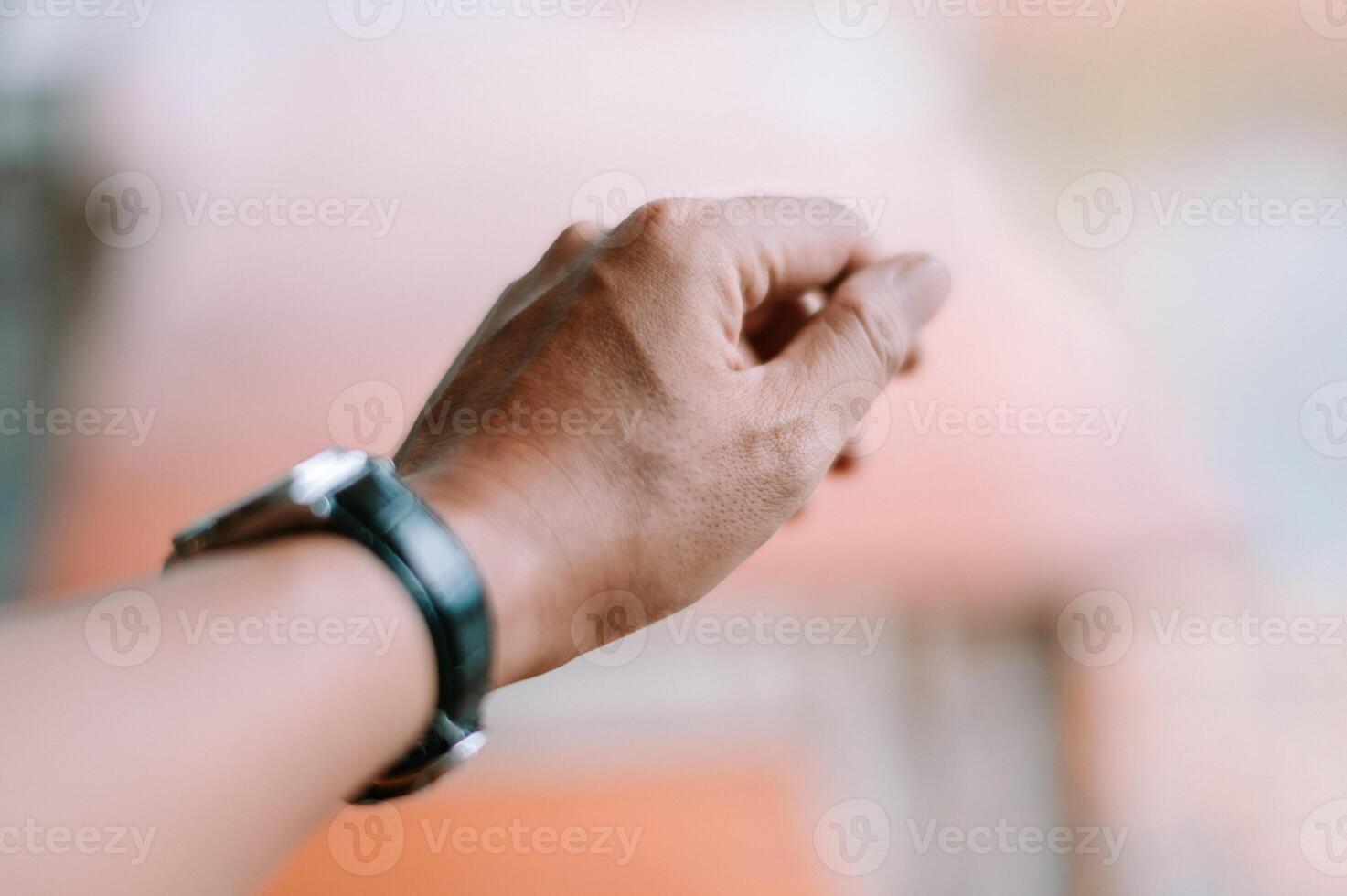 Wristwatch detail emphasizing timeliness and precision of hand gesture photo