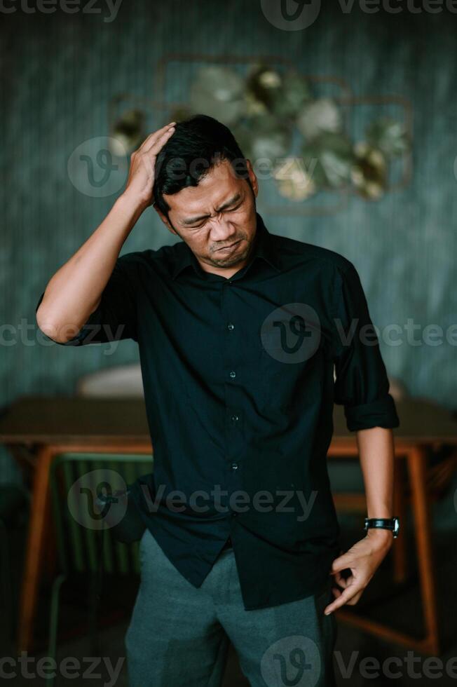 Contemplative businessman experiencing a moment of doubt or deep thinking photo