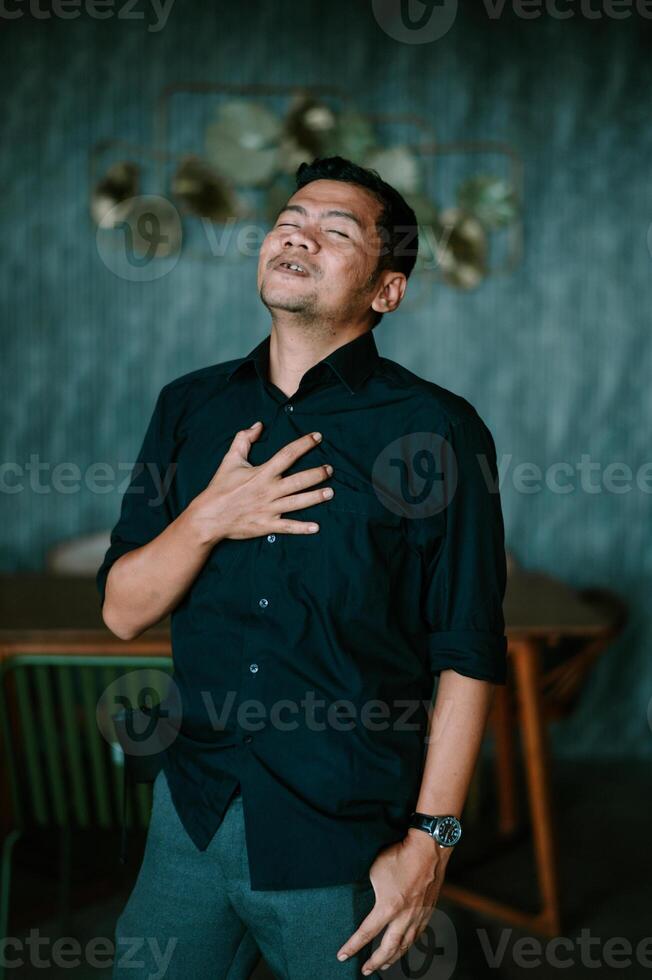 Man experiencing strong emotion with hand on chest in a moment of honesty photo