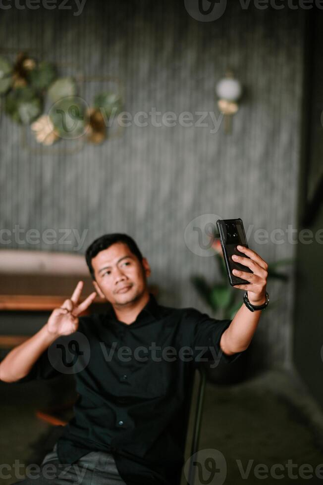 Content creator capturing himself with a smartphone in a stylish interior photo