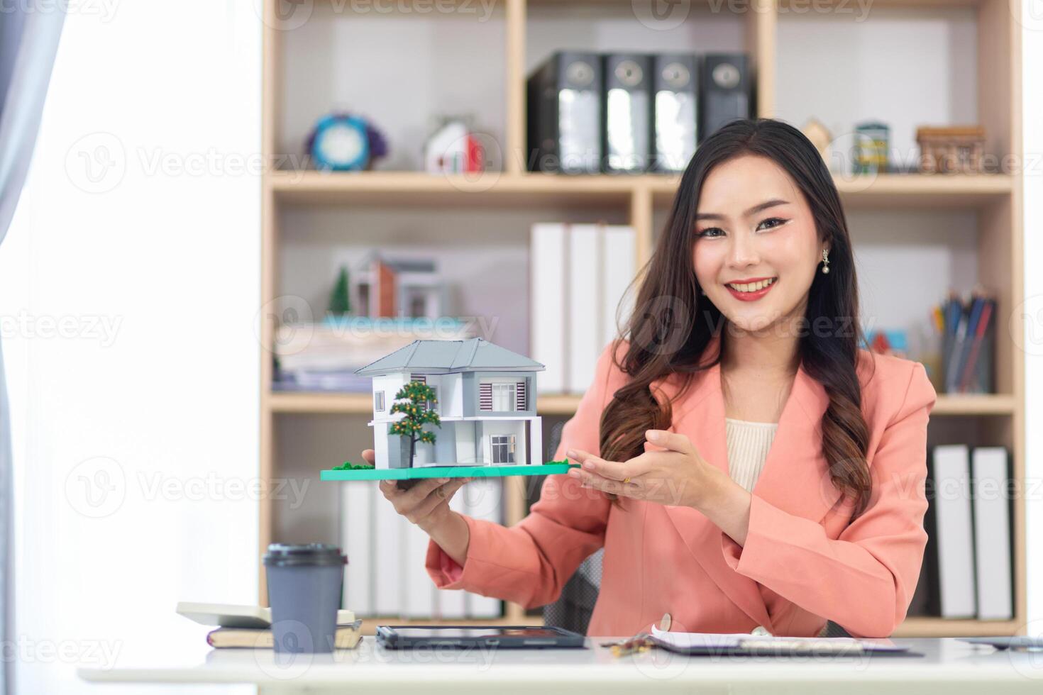 Asian businesswoman runs a real estate brokerage business and is offering her housing estate to potential buyers for large projects and real estate industry continues to grow with population. photo