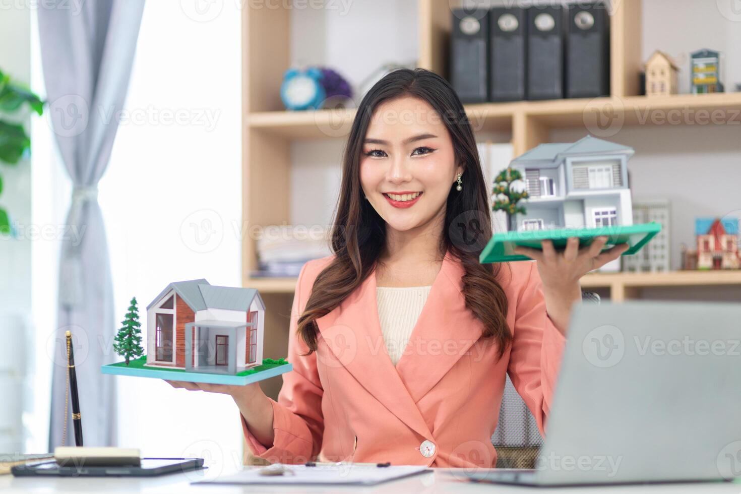 Asian businesswoman runs a real estate brokerage business and is offering her housing estate potential buyers for large projects and real estate industry continues grow with the population. photo