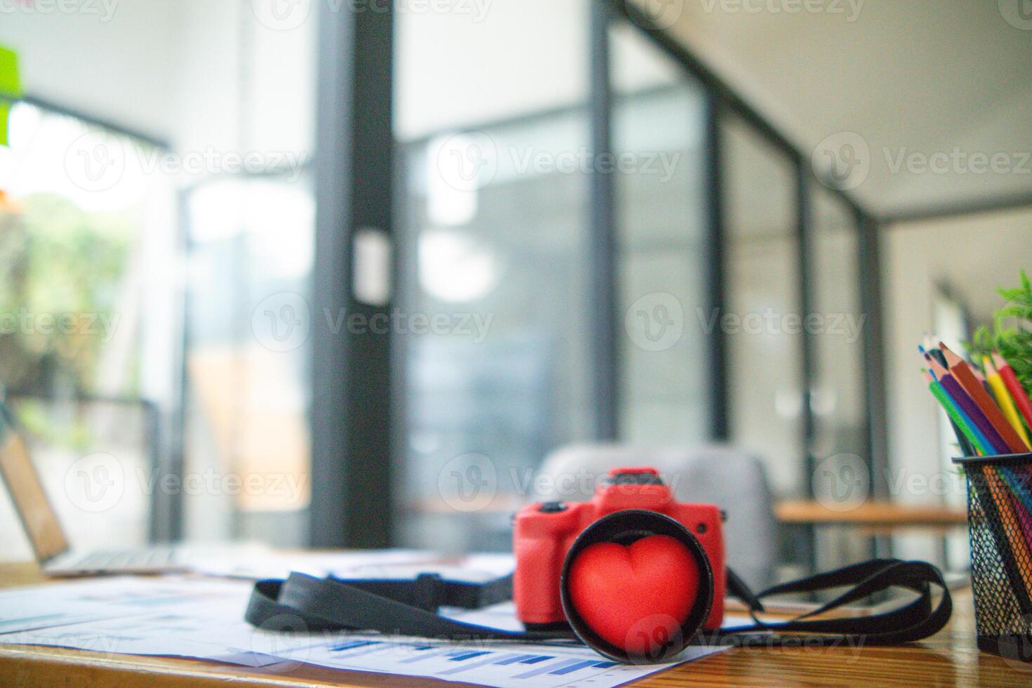 Film cameras and red heart symbol are placed on photographer desk to symbolize the love of photography and the unique tone of the film camera Some photographers are still in love with film cameras. photo