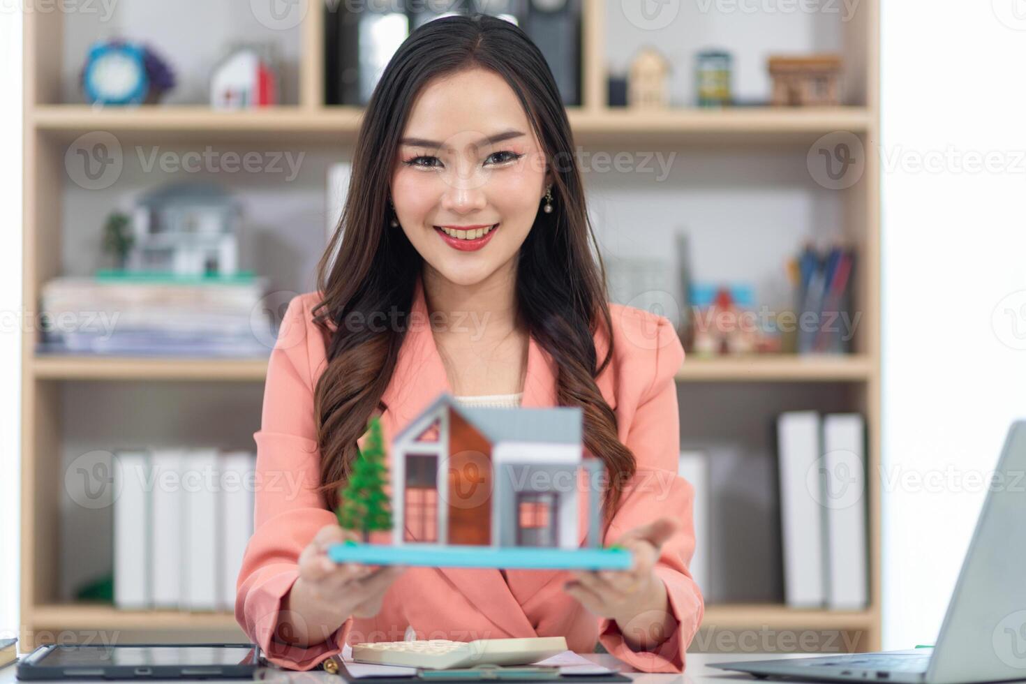 Asian businesswoman runs real estate brokerage business and is offering her housing estate to potential buyers for large projects and real estate industry continues to grow with population. photo