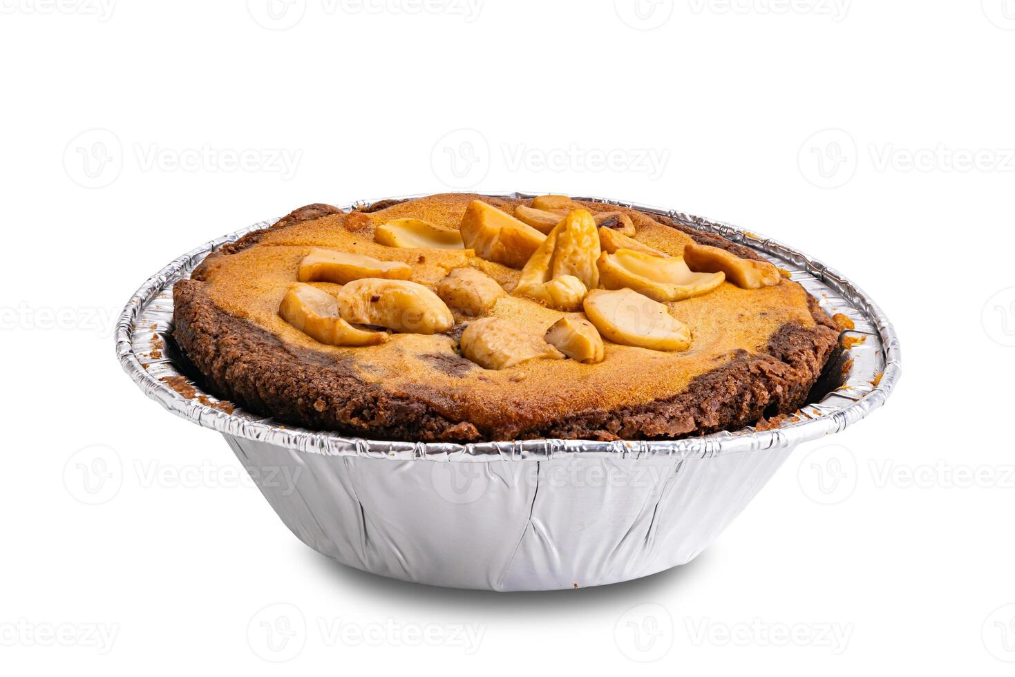 Side view of nut chocolate cake in foil baking cup isolated on white background. photo