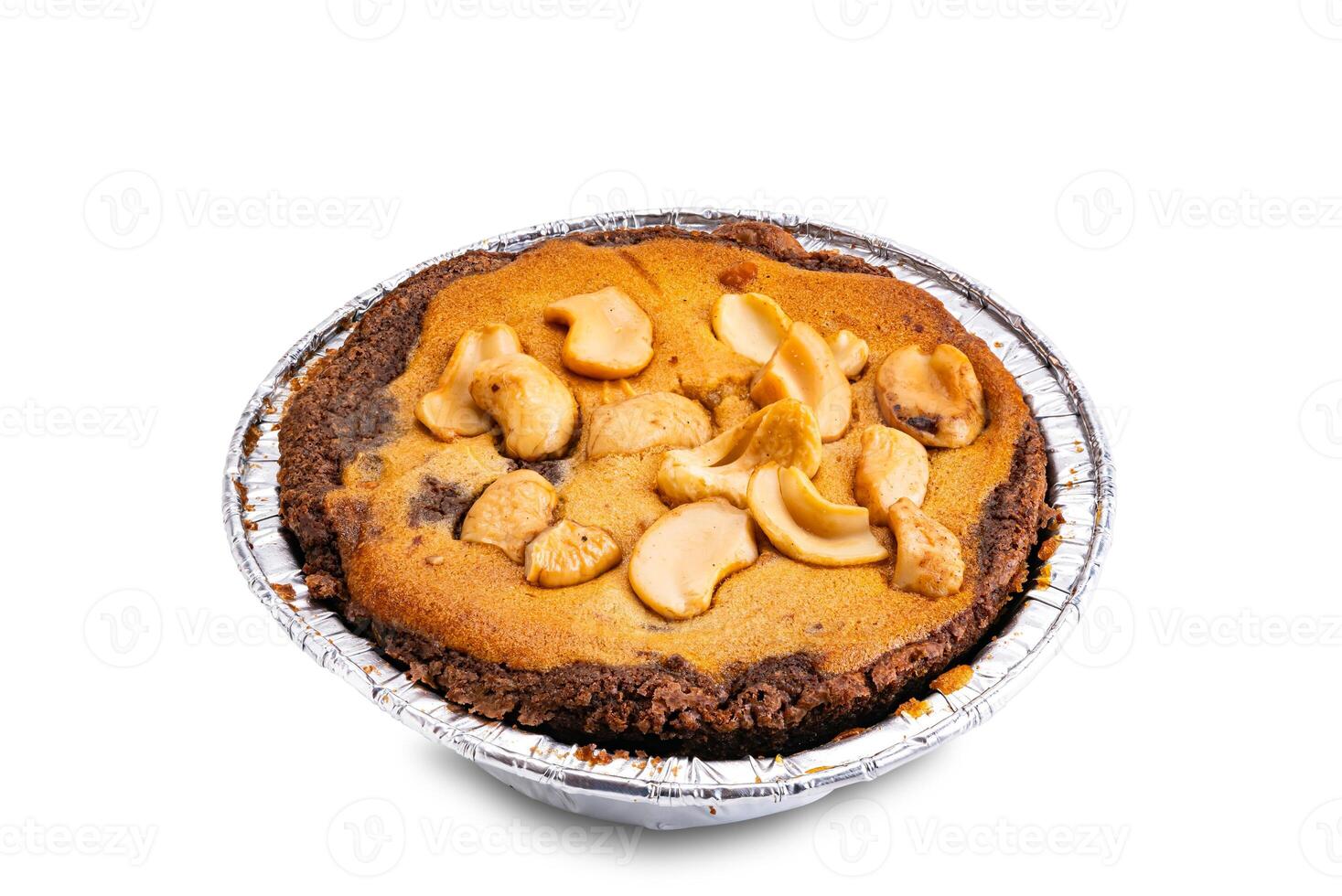High angle view of nut chocolate cake in foil baking cup isolated on white background. photo