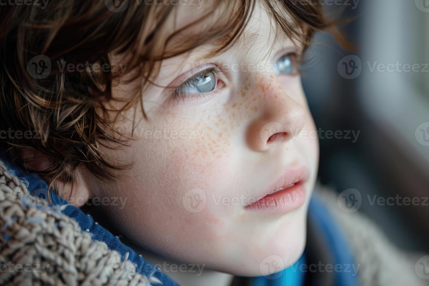 Close up portrait of redhead child with freckles on face on black background photo