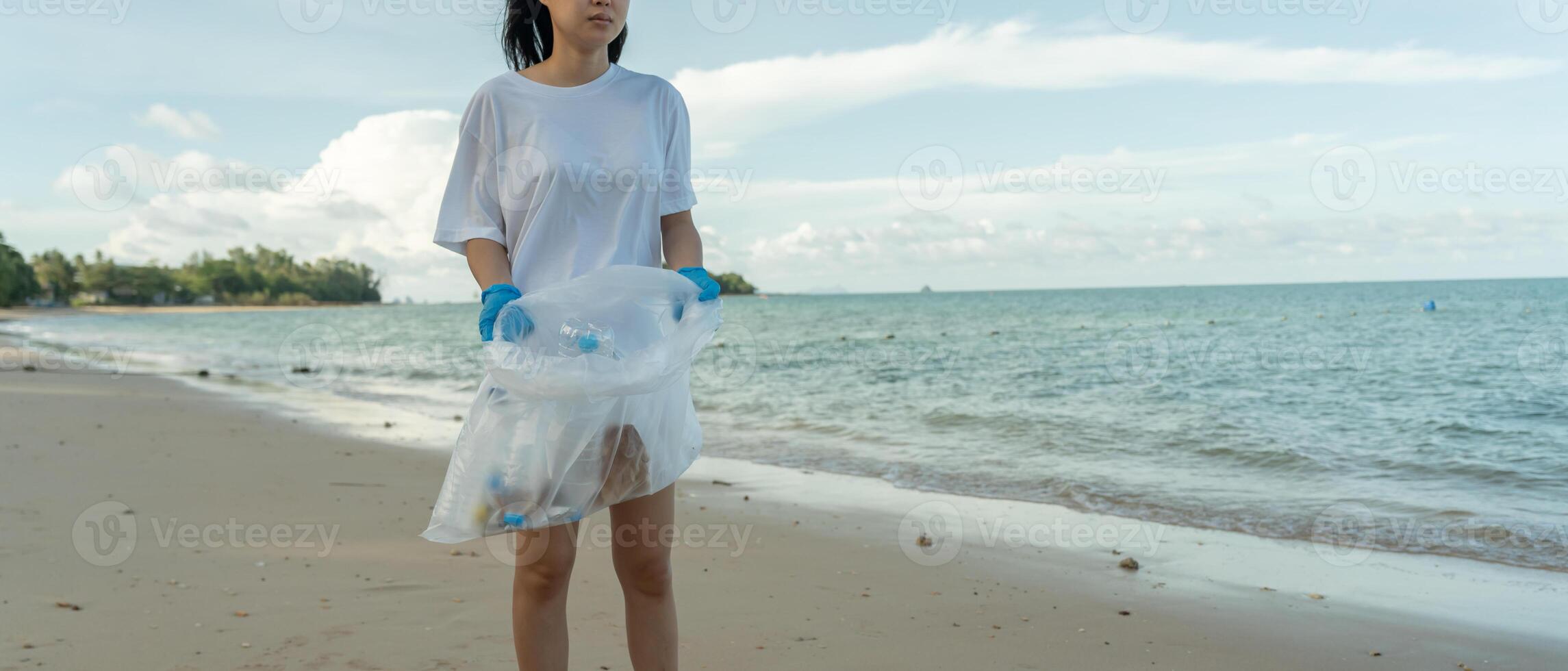 Volunteer pick up trash garbage at the beach and plastic bottles are difficult decompose prevent harm aquatic life. Earth, Environment, Greening planet, reduce global warming photo