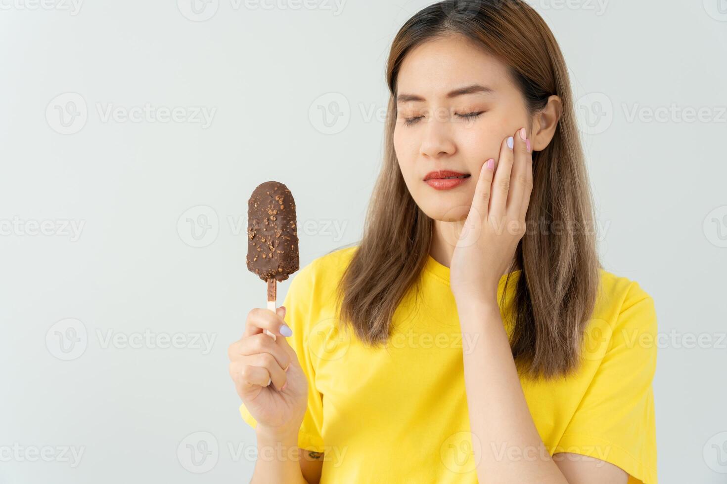 sensitive teeth after eating ice cream, female suffer tooth, decay problems, dental care, tooth extraction, decay problem, bad breath, Gingival Recession, Oral Hygiene instruction. photo