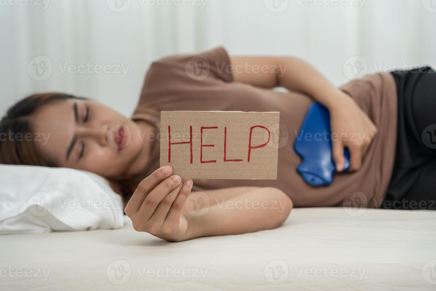 women have abdominal pain and hold help. indigestion, gastritis, menstrual cramps, flatulence, diarrhea, distention, colon cancer, belly inflammation problem, suffer food poisoning photo