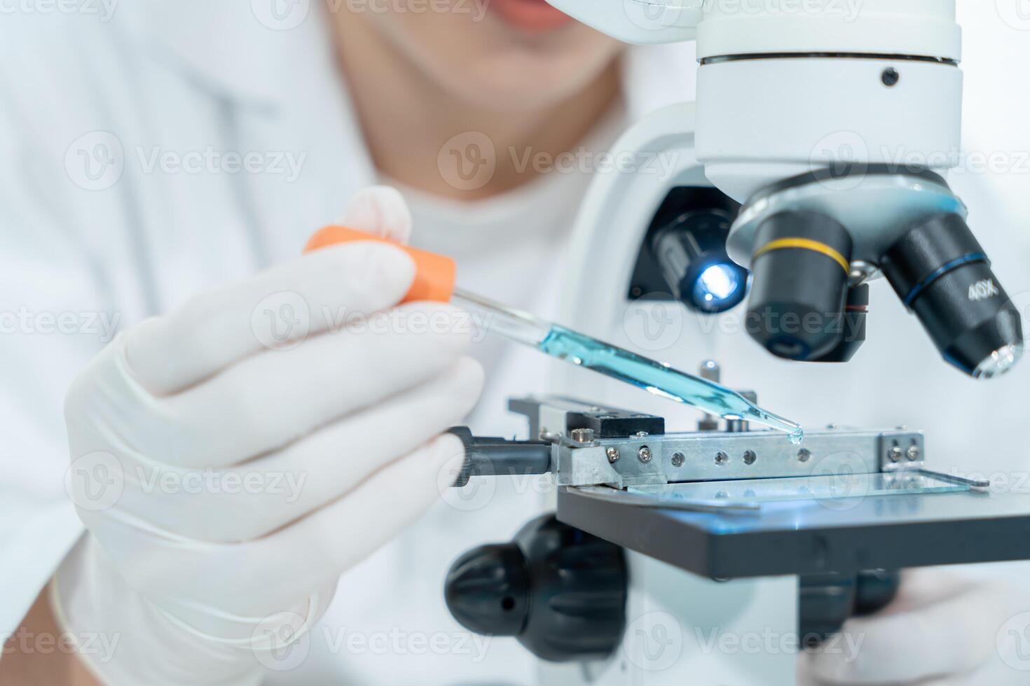 analyze biochemical samples in advanced scientific laboratory. Medical professional use microscope look microbiological developmental of viral. photo