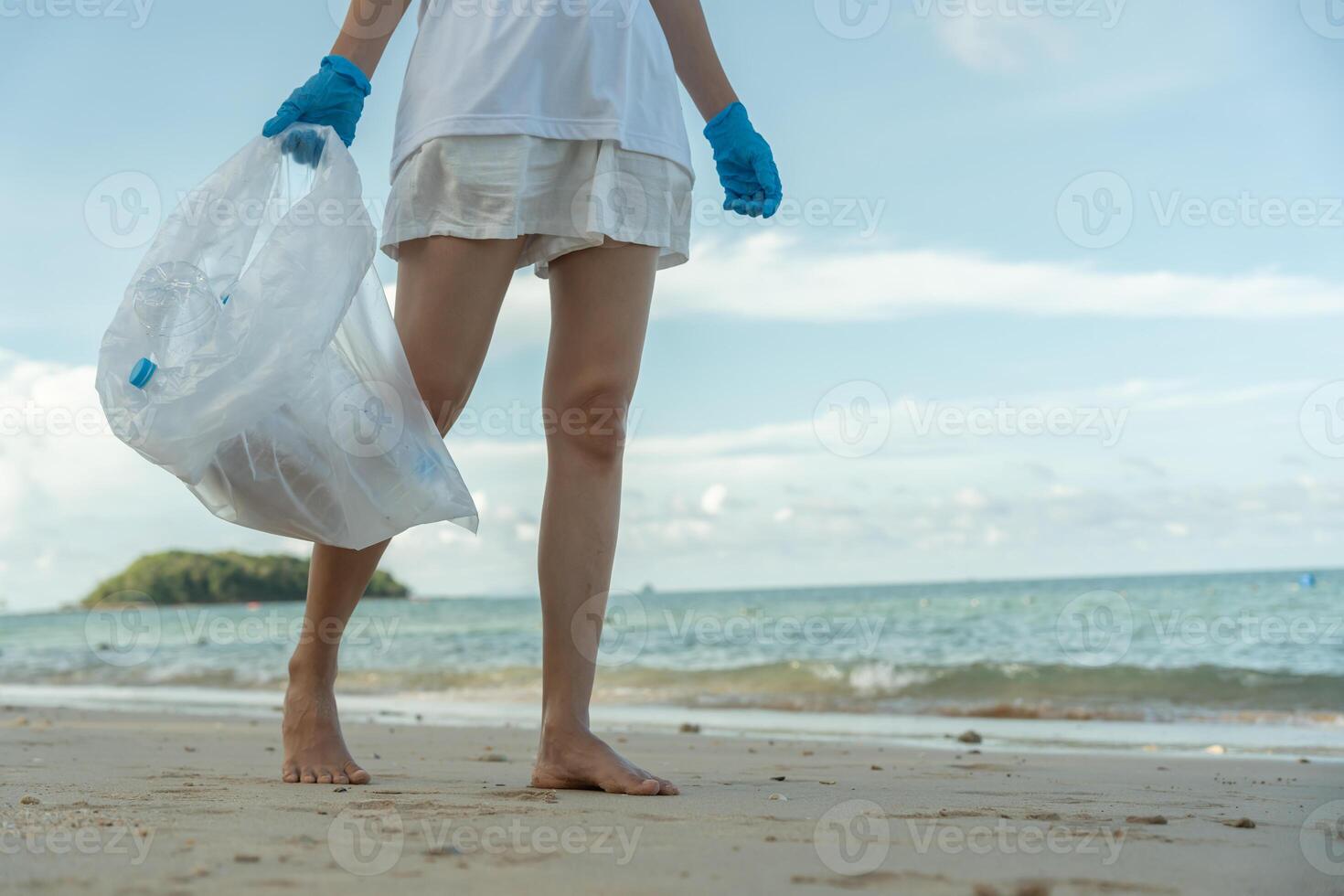 Save water. Volunteer pick up trash garbage at the beach and plastic bottles are difficult decompose prevent harm aquatic life. Earth, Environment, Greening planet, reduce global warming photo