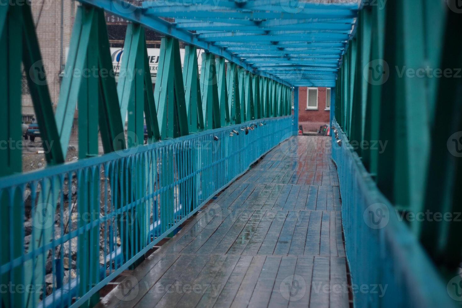 A bridge with blue metal railings and a walkway photo