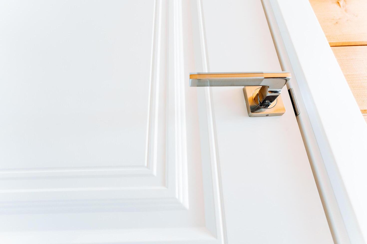 white door with a handle and a door knob photo