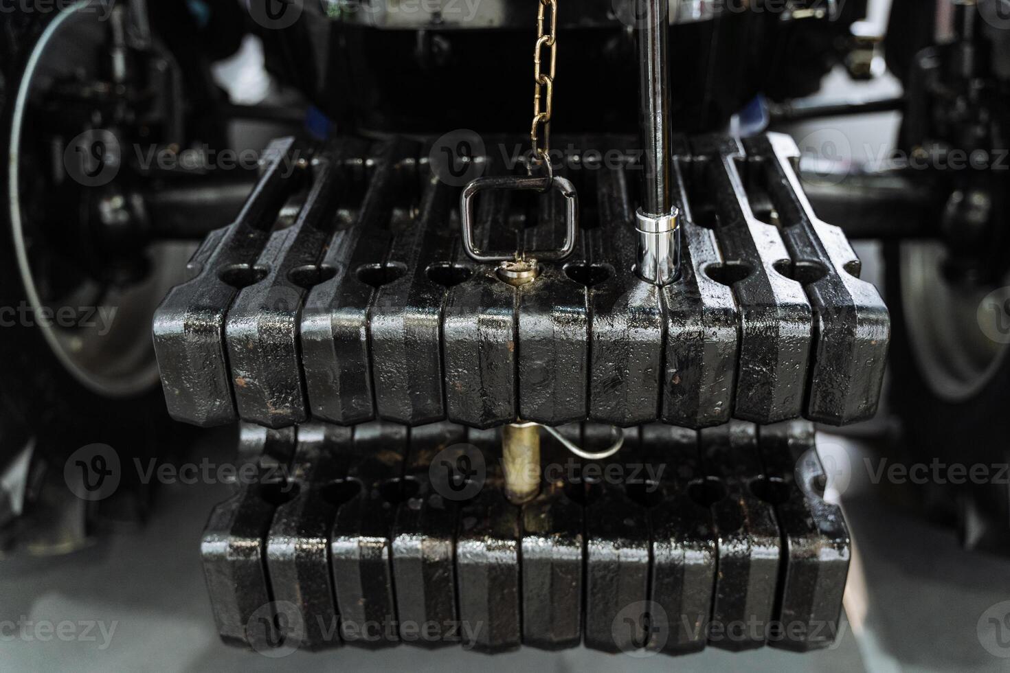 A close up of a tractor with a chain attached to it photo